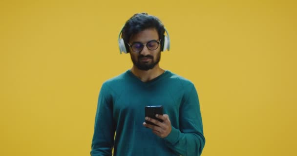 Young man listening music - Filmati, video