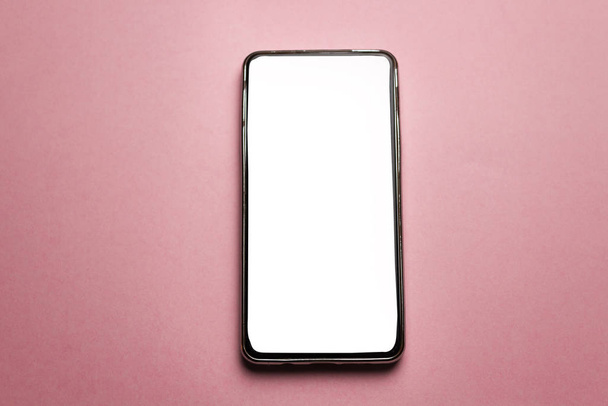 Mobile smartphone isolated on pink background - Photo, Image