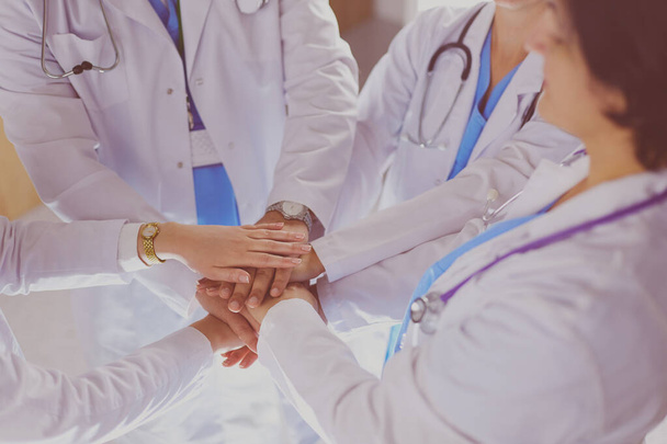 Doctors and nurses stacking hands. Isolated on white - Valokuva, kuva