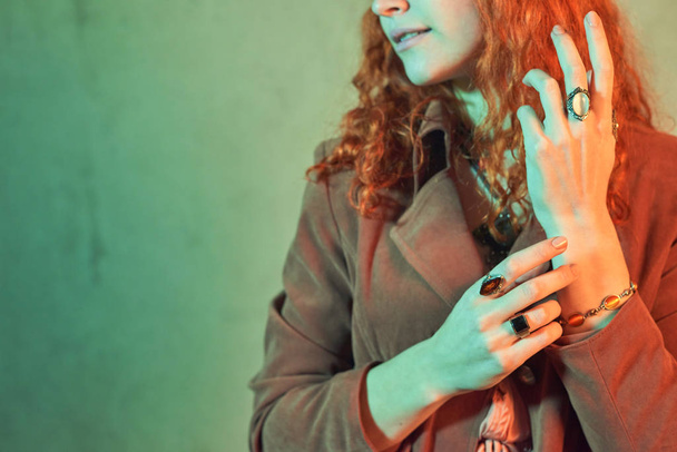 Red haired witch showing her mystic rings and bracelet - Photo, Image