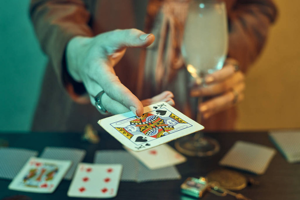 Fortune teller hands with jewelry showing playing cards - Photo, Image