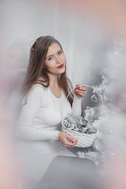 Christmas woman. Happy smiling girl celebrating New Year at Home. - 写真・画像