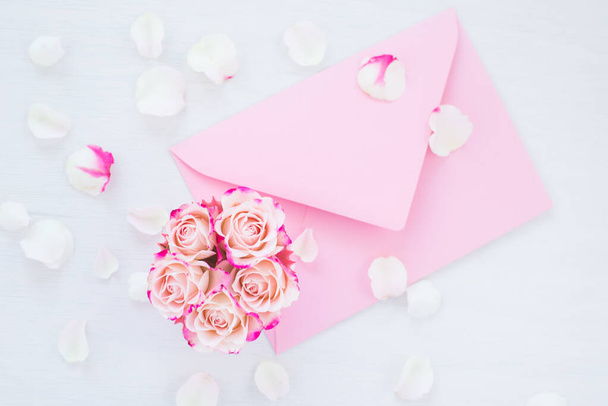 Framework of pink roses and gifts. Spring concept, flat lay, copy space - Photo, image