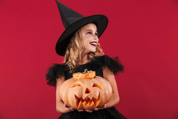 Cheerful little girl wearing Halloween witch costume - Foto, Imagem