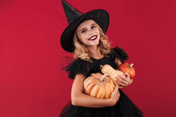 Little girl witch in carnival halloween costume - Fotó, kép