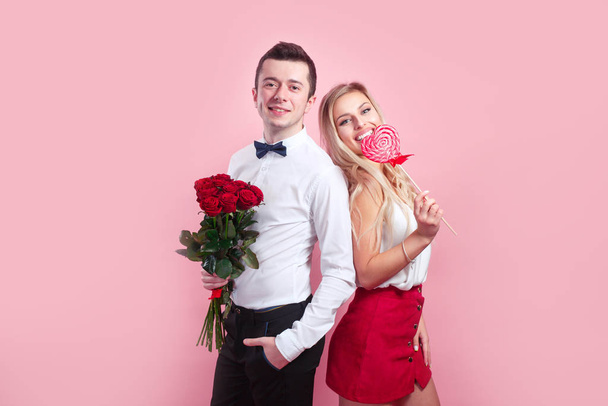 Portrait of happy couple on Valentines Day on pink background. - Фото, зображення