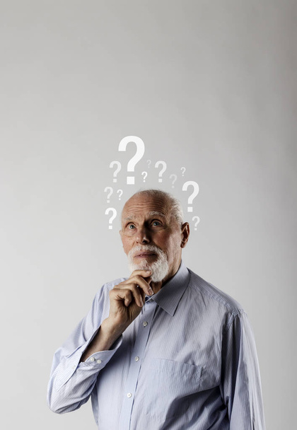 Old man and question marks. Confused old man.  - Photo, Image