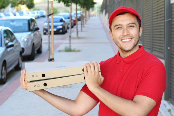 Pizza delivery worker in urban background - Photo, Image