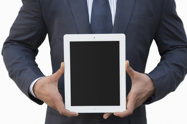 Businessman holding a digital tablet - Fotó, kép