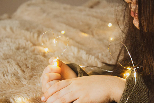 Happy Valentines Day with Heart Shaped Light in Girls Hands - 写真・画像