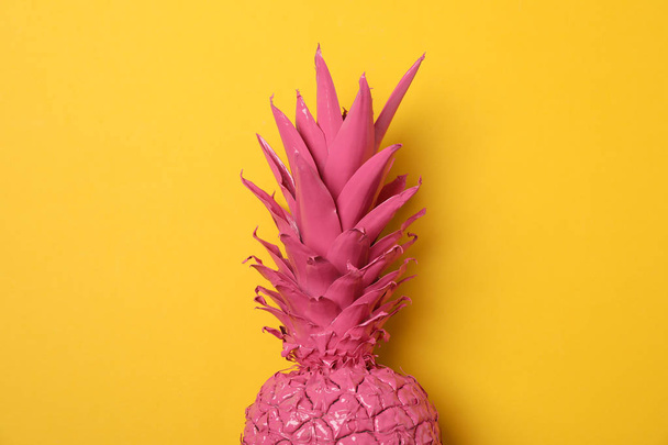 Painted pink pineapple on yellow background, space for text - Valokuva, kuva