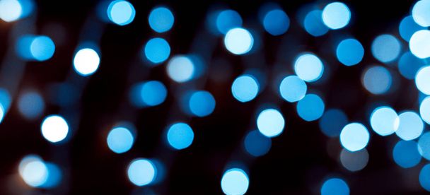 Colourful of city night lights blurred bokeh background. Defocused abstract blue christmas texture - 写真・画像