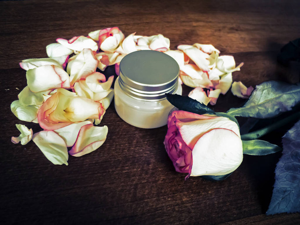 Composición de flores. Rosa crema cosmética. Frasco cerrado de cosméticos
 - Foto, Imagen