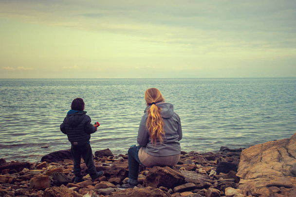 mother and her child looking the sea, two people are waiting for someone to come from far away - Valokuva, kuva