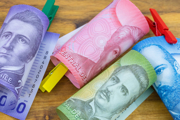 Chilean money with colorful clips, rolled.  Paper banknotes of the country from South America - 写真・画像