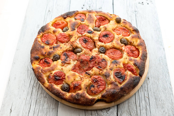 Focaccia typical of Bari Italy with tomatoes and olive - Photo, Image