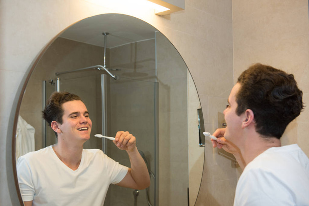 young man brushing teeth - Фото, зображення