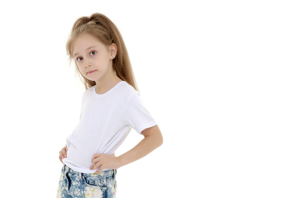 Little girl in a pure white t-shirt for advertising and shorts. - Zdjęcie, obraz