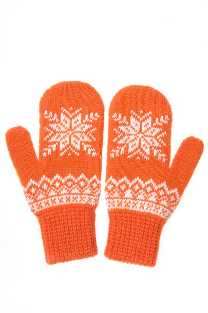 Warm woolen knitted mittens isolated on white background. Orange knitted mittens with pattern - Photo, Image