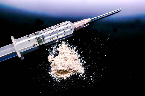 Plastic syringe put in a medical needle and white powder isolate - Photo, Image