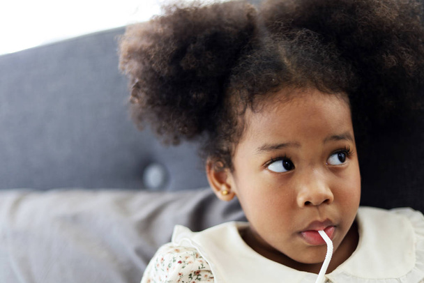Menina afro-americana bonita criança sorrir retrato e beber leite na cama
. - Foto, Imagem