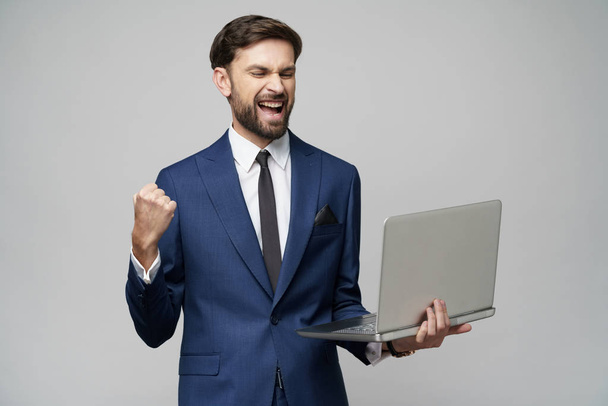 Young handsome businessman Holding a laptop Computer with Blank Screen - Φωτογραφία, εικόνα
