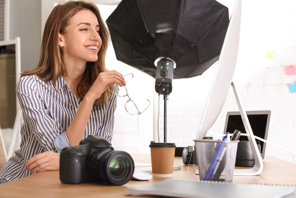 Professional photographer working at table in office - Foto, Bild