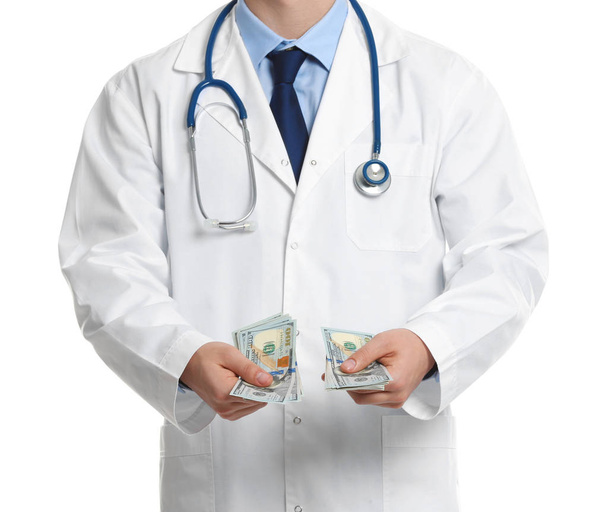 Doctor with bribe on white background, closeup. Corruption in me - Foto, Bild