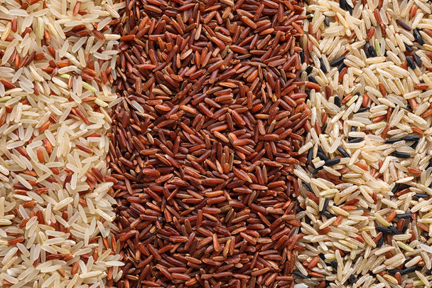 Different types of brown rice as background, top view - Фото, зображення