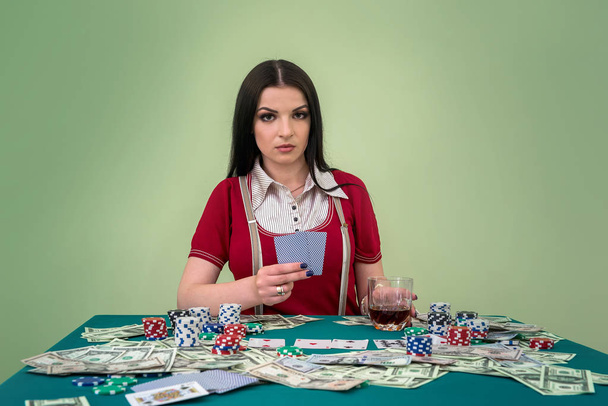 Glamorous brunette woman with playing cards in casino - Photo, image