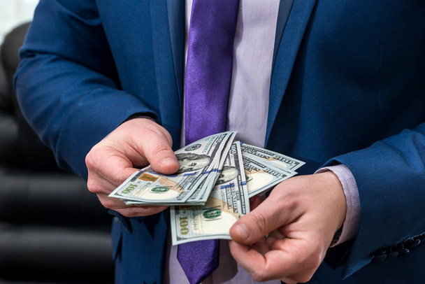 businessman holding large amount of dollar and give you - Photo, Image