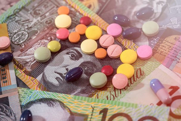 Different dispersed pills on australian dollar banknotes - Photo, Image