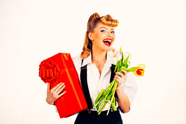 Gifts for Valentines Day. Happy woman with flowers and a box of gifts. Love. - 写真・画像