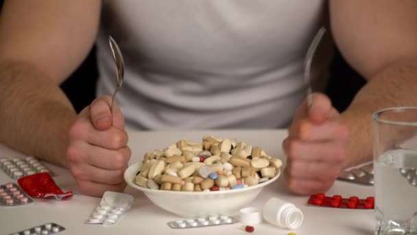 men taking spoon to eat tablets from bowl, pharmaceutical products - Footage, Video
