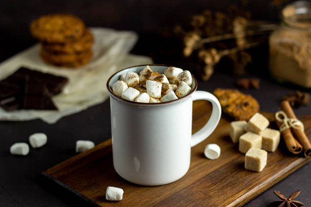 Hot chocolate with marshmallows in a white mug on a rusty background. Winter. Recipes. - Photo, image