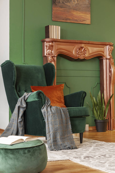 Emerald green wing back chair with orange pillow in luxury living room interior - Foto, Imagem