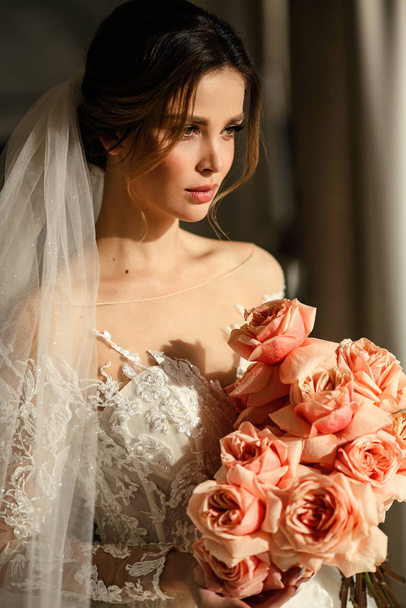 beautiful young bride with dark hair in luxurious wedding dress  - Foto, Imagen