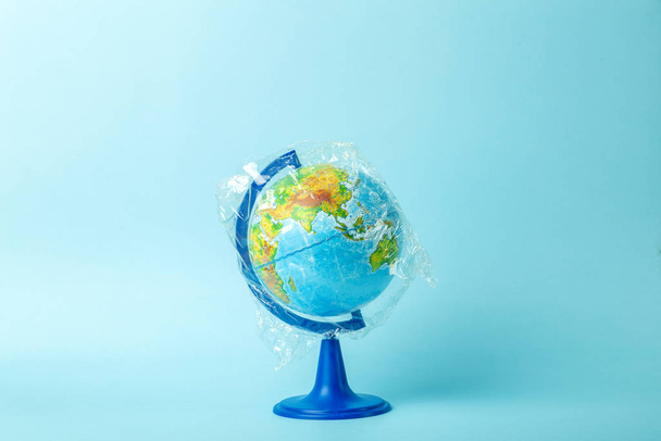 Plastic bag pollution concept. Earth globe in a plastic bag on a - 写真・画像