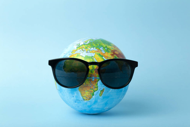 Tourism, ecology, vacation and globalism concept. Globe in sungl - 写真・画像