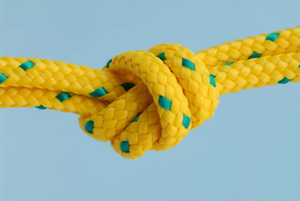 close up of a rope with knot on the blue background - Фото, зображення