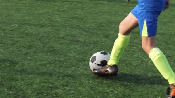 Feet of skillful preteen soccer forward with ball - Footage, Video