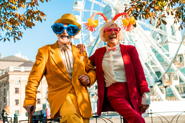 Happy older lady in clown accessories standing near her husband - Fotografie, Obrázek