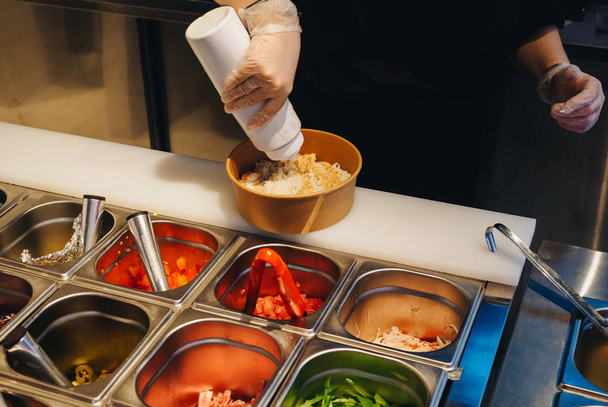 Cooking of poke bowls from ingredients in cafe - Φωτογραφία, εικόνα