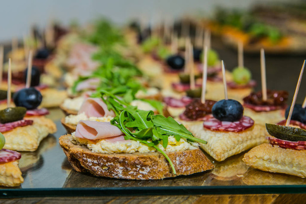 Detail of a canapes of a meal at an event, wedding, meeting or congress with food. Canapes decorated on the dish  - Foto, Imagen