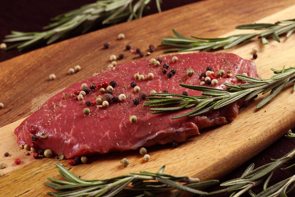 uncooked beef pepper steak with pepper and rosemary, healthy eating concept - Foto, afbeelding