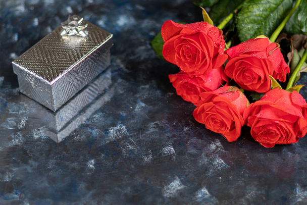 Mother's day, women's day, Valentine's day or birthday on a dark blue background. Roses and box packaging. Congratulatory banner, card. - Φωτογραφία, εικόνα