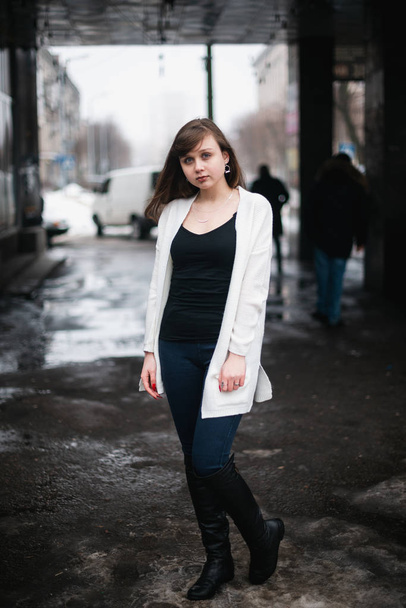 Girl in winter in a cardigan on a street in the city - Фото, зображення