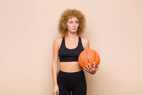 young afro woman feeling sad, upset or angry and looking to the side with a negative attitude, frowning in disagreement sport concept - Fotografie, Obrázek