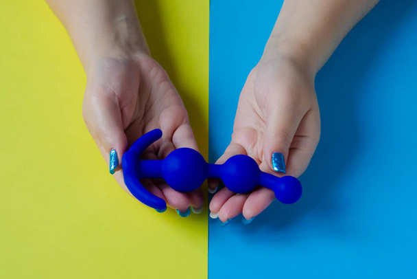Sex toy. Butt plug in the hand. Blue anal toy - Photo, Image