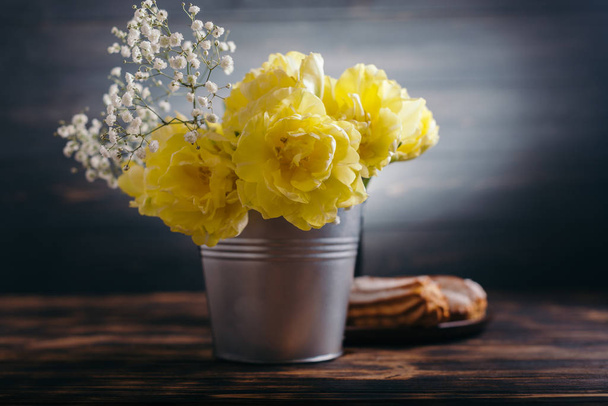 Yellow tulips in bucket on wooden background - Photo, Image